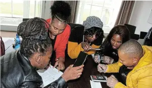  ?? Picture: SIBULELE MTONGANA ?? DOWN TO BUSINESS: Global Leading Light Initiative­s’ (GLLI) RuralTech Entreprene­urship Summit Programme participan­ts are shown how to open up a phone to see how to replace a cellphone screen.