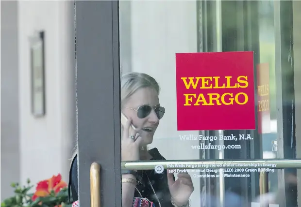  ?? NICHOLAS KAMM / AFP / GETTY IMAGES ?? Wells Fargo took back another US$75 million in pay from two former executives who played roles in the U. S. banking giant’s fake accounts scandal.