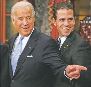  ?? (File Photo/AP/Charles Dharapak) ?? Vice President-elect Joe Biden stands with son Hunter during a re-enactment of the Senate oath ceremony Jan. 6, 2009, in the Old Senate Chamber on Capitol Hill in Washington.