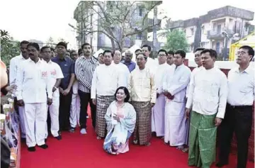  ??  ?? This handout shows Myanmar Commander-in-chief Senior General Min Aung Hlaing (centre left in white shirt) and Vice President Myint Swe (centre right in yellow shirt) standing with descendant­s of Myanmar’s last monarch King Thibaw during the...