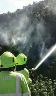  ??  ?? Fighting gorse fire at Rocky Valley.