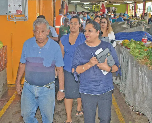  ?? Photo: Ronald Kumar ?? Minister for Local Government Premila Kumar with Suva market vendors Jeke Pae and Sofia Talei followed by ministry officials and Suva City Council staff at Suva Municipal Market on April 1, 2020.