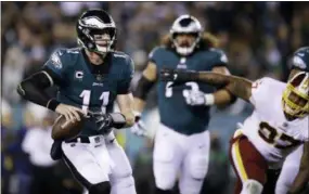  ?? MATT ROURKE — ASSOCIATED PRESS ?? Eagles quarterbac­k Carson Wentz looks to pass during the first half Monday night.