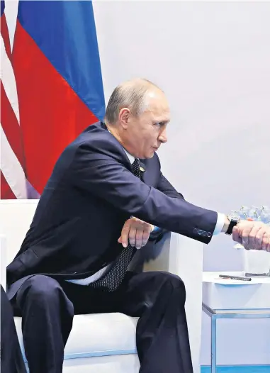  ??  ?? Vladimir Putin shakes hands with Donald Trump during their meeting at the G20 summit in Hamburg yesterday. Mr Trump said it was an ‘honour’ to meet the Russian president and the pair discussed Syria, the North Korean nuclear crisis and cyber security