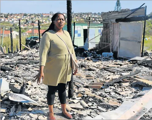  ?? Picture: SIBONGILE NGALWA ?? SAD DAY: Heartbroke­n principal Thantaswa Bashman surveys the burnt remains of the Masibulele Daycare centre, which catered for children aged between one and five years. The fire has been blamed on thieves who broke into the centre on Sunday night