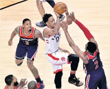  ?? AP ?? The Raptors’ DeMar DeRozan, No.10, drives to the basket against the Wizards in Toronto.