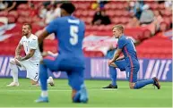  ??  ?? England and Romanian players take a knee before their match earlier this week.