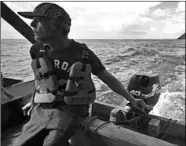  ??  ?? The captain of a fishing boat sails off the coast while participat­ing in the search for victims of a shipwreck in Guiria, Venezuela, on December 18. (Photo:Al Jazeera)