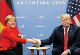  ?? REUTERS ?? US President Donald Trump and German Chancellor Angela Merkel shake hands during a meeting at the G20 leaders’ summit in Buenos Aires, Argentina, on 1 December 2018.