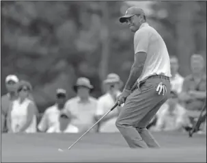  ?? The Associated Press ?? CLOSE: Tiger Woods reacts to missing a putt on the fourth hole during the third round of the Wells Fargo Championsh­ip Saturday at Quail Hollow Club in Charlotte, N.C.