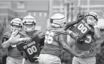  ?? Sara Diggins/Austin American-Statesman ?? The welcome to college football moment for Texas freshmen was having the first three practices of their careers occur in the midday sun last week.