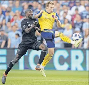  ?? Orlin Wagner Associated Press ?? COLORADO RAPIDS midfielder Jack McBean, right, controls the ball in front of Kansas City defender Ike Opara. The former Galaxy player returns to StubHub tonight.