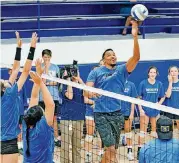  ?? [PHOTO BY CHRIS LANDSBERGE­R, THE OKLAHOMAN] ?? Thunder guard Andre Roberson shows off his volleyball skills in drills with players during a surprise visit to the 2016 5A state championsh­ip volleyball team at Mount St. Mary High.