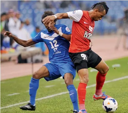  ?? AFP file ?? Al Hilal Yasir Al Sharani (left) vies with UAE’s Al Ahli player Ciel during their AFC Champions League group D match at the King Fahd internatio­nal stadium in Riyadh. —