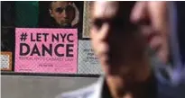  ??  ?? A poster speaking on repealing New York’s dance prohibitio­n is seen hanging outside a bar in New York City. — AFP