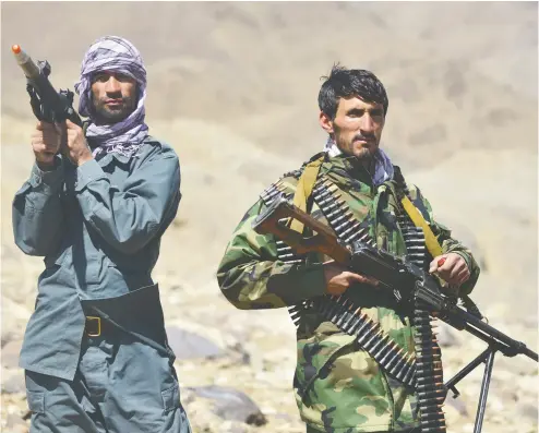  ?? AHMAD SAHEL ARMAN / AFP VIA GETTY IMAGES ?? Afghan resistance movement and anti-taliban uprising forces stand guard at an outpost in Kotal-e Anjuman of Paryan district in Panjshir province as the Taliban said their fighters had surrounded resistance forces.