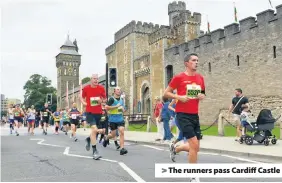  ??  ?? &gt; The runners pass Cardiff Castle