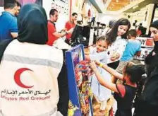  ?? Clint Egbert/Gulf News ?? Rawafed Centre volunteers take underprivi­leged children to the RedTag department store for shopping on Monday.