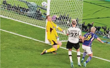 ?? Ricardo Mazalan / Associated Press ?? Takuma Asano (right) scores Japan’s second goal past Germany goalkeeper Manuel Neuer.