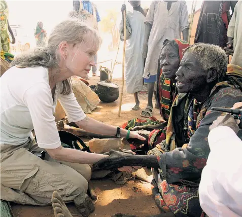  ??  ?? Van Hauwermeir­en, pictured above left in a meeting with Mia Farrow, the actress, in Chad in 2007, and Farrow talking to villagers in Goz Beida, Chad