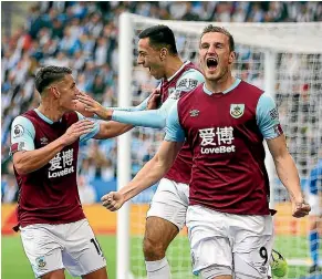  ?? AP ?? Chris Wood celebrates scoring Burnley’s first goal against Leicester City but had another later disallowed by the video referee.