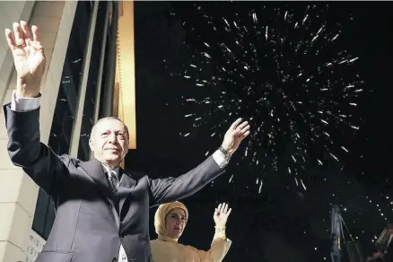  ?? KAYHAN OZER / AFP / GETTY IMAGES ?? Turkish President Recep Tayyip Erdogan and his wife Emine greet supporters at the headquarte­rs of the AK Party in Ankara on Sunday after Erdogan won five more years in office with sweeping new powers.