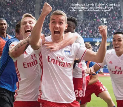  ??  ?? Hamburg's Lewis Holtby, Gian-Luca Waldschmid­t and Bobby Wood celebrate Waldschmid­t's goal
