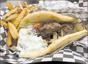  ?? Arkansas Democrat-Gazette/ERIC E. HARRISON ?? The Lamb Gyros and fries combo at Jacobs Wings comes in a paper-lined plastic basket.