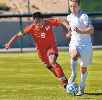  ?? JIM THOMPSON/JOURNAL ?? West Mesa’s Agustin Paulino, left, battles La Cueva’s Jake Eanes for the ball during Saturday’s game at the APS Soccer Complex. The Bears won 2-1 to finish 8-0 in District 2-5A.
