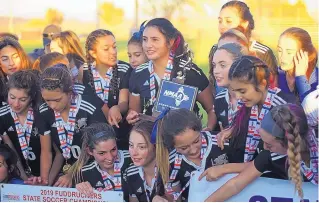  ?? ADOLPHE PIERRE-LOUIS/JOURNAL ?? The St. Pius team members celebrate postgame after defeating rival Academy 2-1 in Friday’s Class 4A girls state championsh­ip match. The Sartans ended the Chargers’ three-year reign.