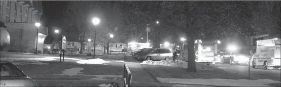  ?? Mona Weatherly ?? Above, emergency response vehicles are pictured outside Custer Heights Apartments (far left in photo) last Thursday night. Carbon monoxide detectors went off. Malfunctio­ning equipment and lack of ventilatio­n was found to be the cause.