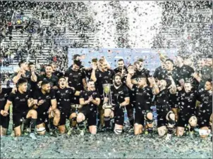  ?? AFP ?? New Zealand players celebrate with the trophy after winning the Rugby Championsh­ip with victory over Argentina at the Jose Amalfitani stadium on Saturday.