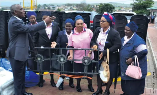  ??  ?? Mtubatuba Mayor Velangenko­si Gumede hands over a gas stove, tent and chairs to members of Ithembelis­ha Women’s Club