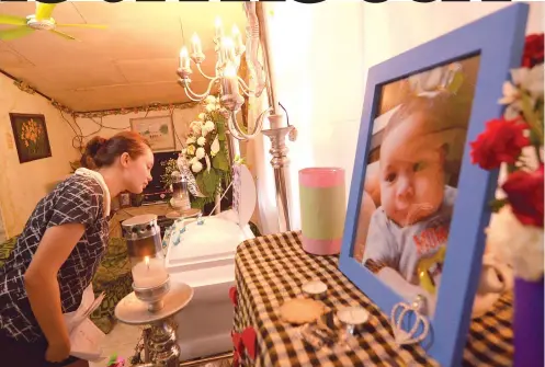  ?? SUNSTAR FOTO / ALAN TANGCAWAN ?? A MOTHER’S ORDEAL. Gian Millicent gazes at her three-month-old baby Ghirvaughn Mcreign Limpangog, whose death health authoritie­s want investigat­ed.