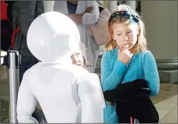  ??  ?? In this Dec 22, 2016 photo, Emerson Hill, 6, plays with Pepper the robot at Westfield Mall
in San Francisco. (AP)