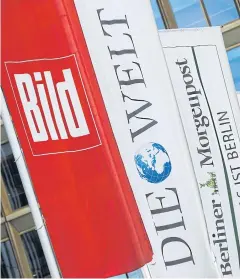  ?? REUTERS ?? Flags with the logos of the main newspapers of German publisher Axel Springer fly outside its headquarte­rs in Berlin in this August 7, 2013 file photo.