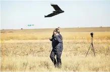  ??  ?? Mayor Naheed Nenshi ducks after a failed drone launch Friday, while at the newly opened Point Trotter Autonomous Systems Testing Area.