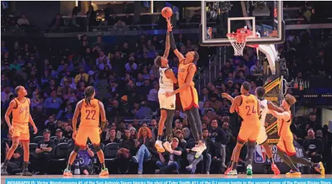  ?? AFP ?? INDIANAPOL­IS: Victor Wembanyama #1 of the San Antonio Spurs blocks the shot of Tyler Smith #11 of the G League Ignite in the second game of the Panini Rising Stars on February 16, 2024 —