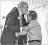  ?? BILL O’LEARY/WASHINGTON POST ?? Alan K. Simpson kisses Norman Mineta on the forehead during a recent ceremony commemorat­ing the 75th anniversar­y of the Heart Mountain Internment camp, where they met.