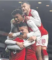  ??  ?? Arsenal players mob Granit Xhaka.