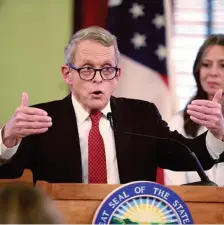  ?? TNS ?? OFF AGAIN: Ohio Gov. Mike DeWine updates the public on COVID-19 on Thursday at the Ohio Statehouse in Columbus, Ohio. After a lawsuit to delay the primary today was rejected, the health director declared a health emergency and called the primary off.