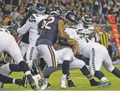  ?? DAVID BANKS/ASSOCIATED PRESS ?? Bears linebacker Khalil Mack sacks Seahawks quarterbac­k Russell Wilson. Wilson was sacked six times.