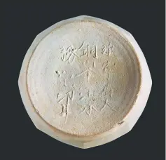  ??  ?? Ceramic box base with Chinese inscriptio­n which dates from AD 1162 to 1278 recovered from the Java Sea shipwreck.