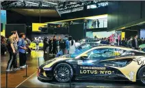  ?? LI FUSHENG / CHINA DAILY ?? Visitors inspect Lotus’ cars at the Guangzhou auto show in November.