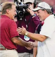  ?? Sam Craft/Associated Press ?? Alabama coach Nick Saban, left, accused coach Jimbo Fisher, right, and Texas A&M of buying top players in A&M’s No. 1 recruiting class.