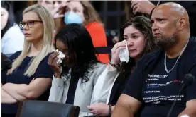  ?? ?? Sandra Garza, partner of Brian Sicknick and Serena Liebengood, widow of US Capitol police officer Howie Liebengood cry as Erin Smith, widow of DC police officer Jeffrey Smith and former Washington police officer Harry Dunn look on, Photograph: Jonathan Ernst/ Reuters
