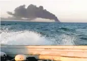  ?? ASRIRAN.COM ?? An image from video taken Wednesday shows smoke rising from the largest warship in Iran’s navy after it caught fire. The ship later sank in the Gulf of Oman.