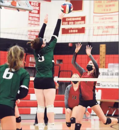  ?? Dave Phillips / For Hearst Connecticu­t Media ?? Cheshire's Tess Givens keeps her eye on the ball on a return from Guilford's Corrine Puchalski during a volleyball match Monday night.