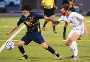  ?? ADOLPHE PIERRE-LOUIS/JOURNAL ?? Highland’s Luis Martinez, left, and Albuquerqu­e Academy’s Jude Logan vie for possession during their Class 4A boys state tournament game on Tuesday. The visiting Chargers prevailed 2-0.