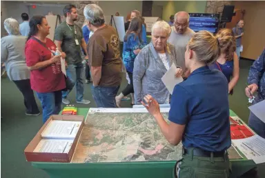  ??  ?? Local officials explain to residents how the Museum Fire would affect them during a community meeting at Flagstaff High School on Tuesday. MADELEINE COOK/THE REPUBLIC